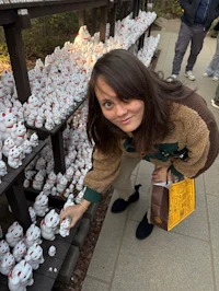 a woman leaning over a shelf full of figurines